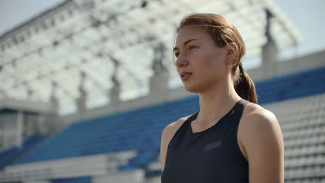 Slow-motion:-woman-athlete-waits-for-start-of-race-in-400-meters.-girl-athlete-waits-for-start-of-race-in-100-meters-during.-Running-at-the-stadium-from-the-pads-on-the-treadmill